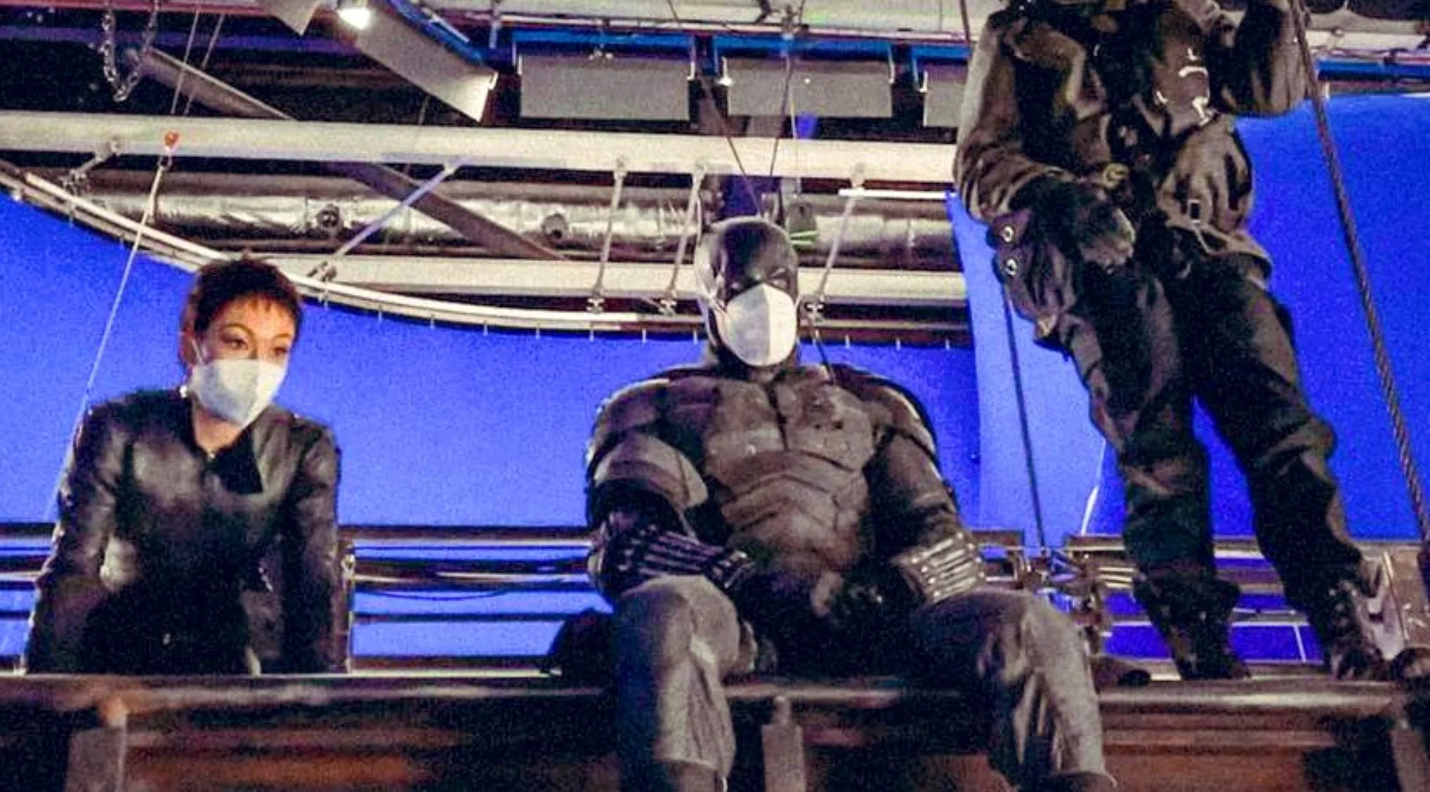 BTS image shows a cast and crew wearing masks on a movie set with a blue screen. Guess the movie.