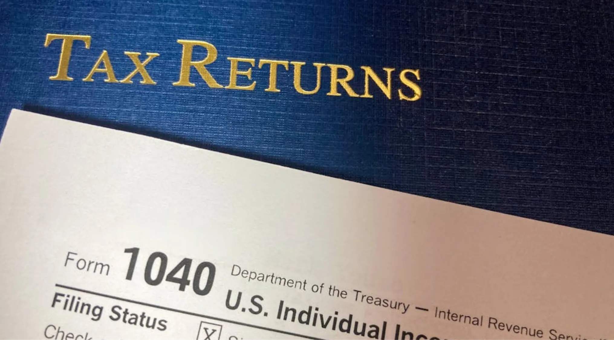 Tax Returns folder with a tax form, relating to who collects taxes in Australia and Australian Citizenship.