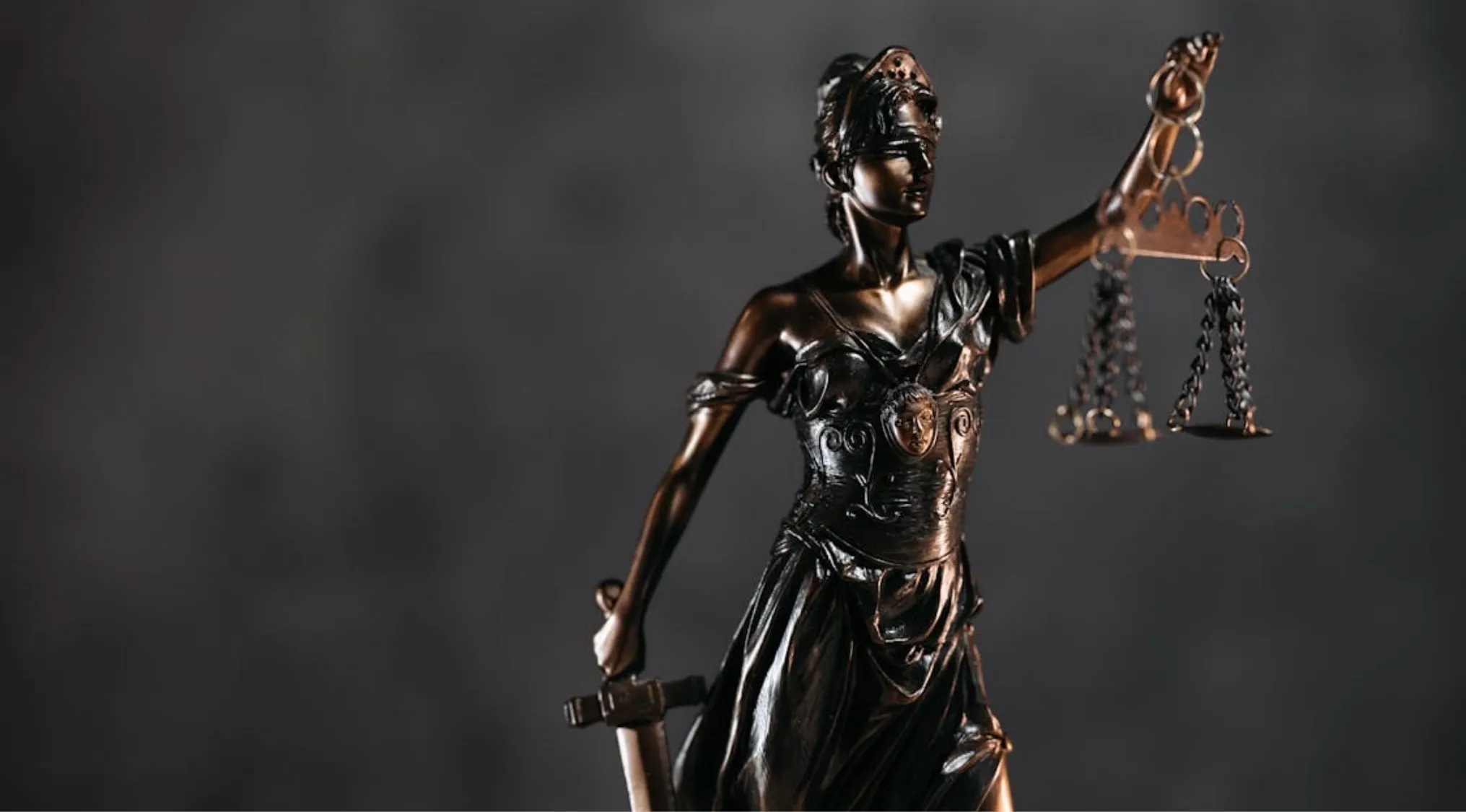 Bronze statue of Lady Justice with scales and sword. Symbolizing the 'fair go' principle in Australian Citizenship.