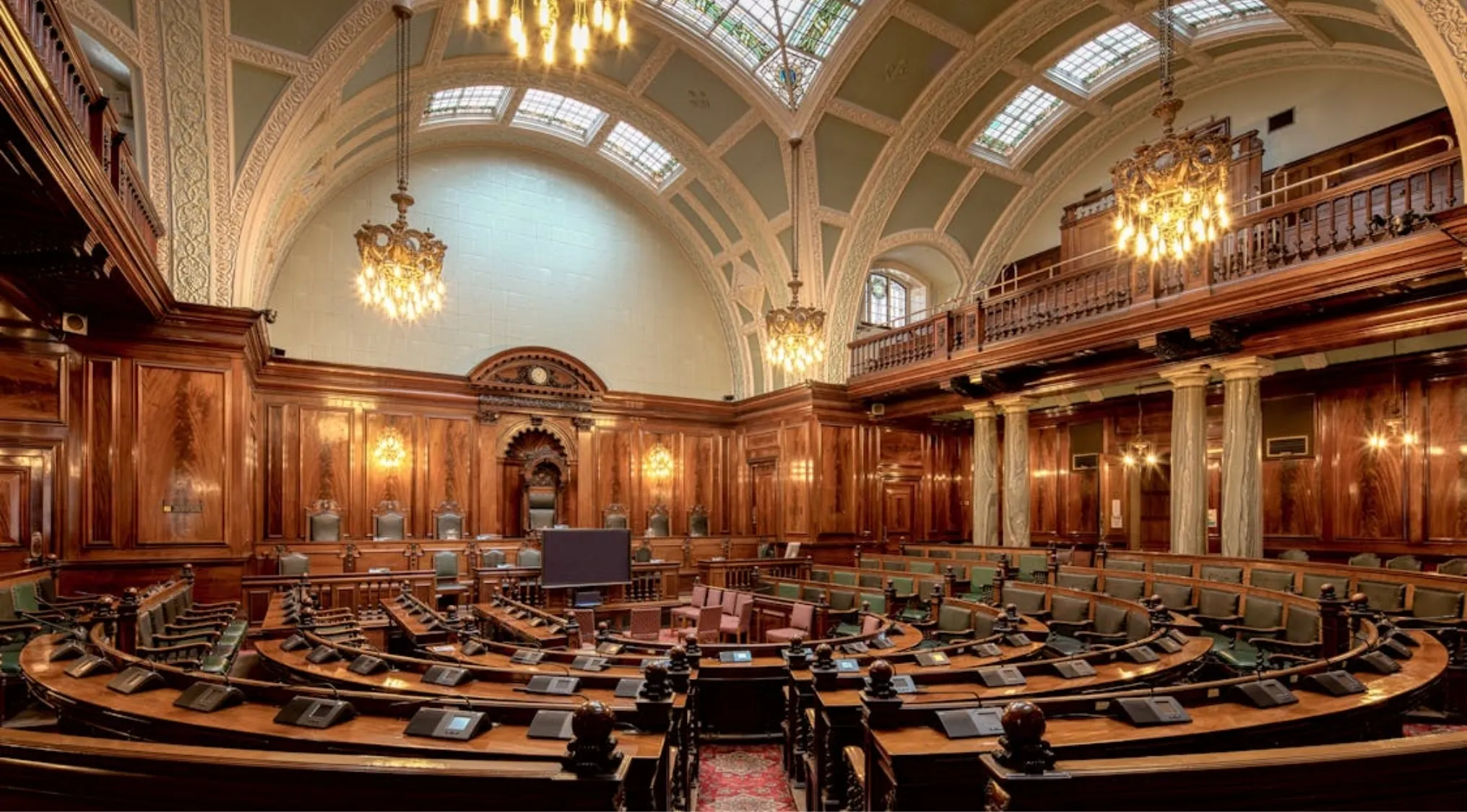 A grand, ornate Australian courthouse interior, featuring judges and magistrates' benches and a large meeting area, highlighting the legal system.