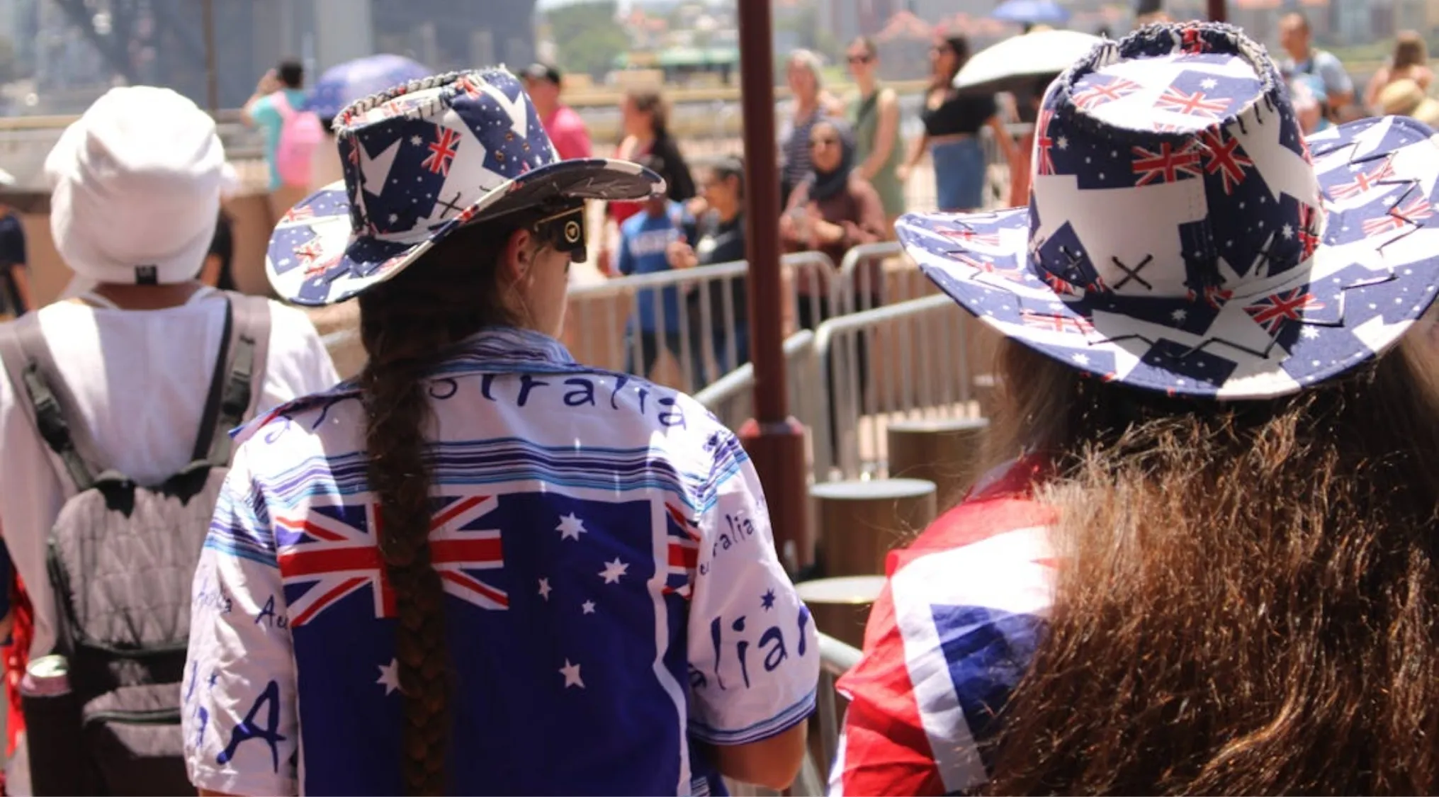People wearing Australian flag shirts and cowboy hats celebrating Australian Citizenship on Australia Day.