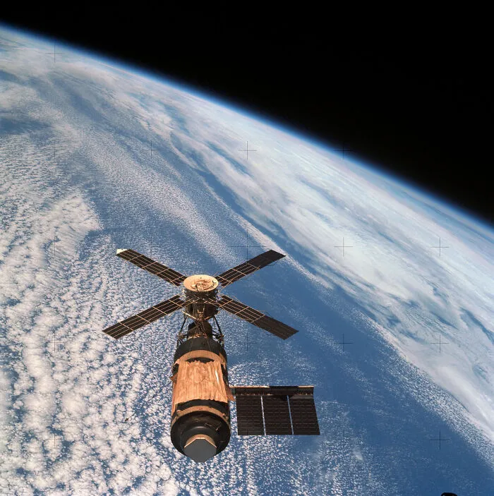 Satellite orbiting Earth with visible clouds and atmosphere, illustrating historical events from the year you were born.