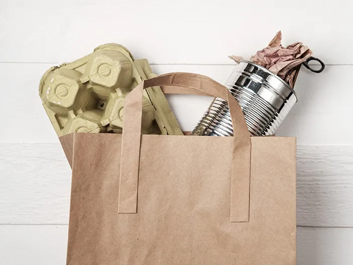 Brown paper grocery bag with recycled packaging and canned goods symbolizing rude customers learning the hard way not to mess with staff.