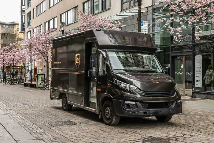 UPS delivery truck on a city street with blooming trees, illustrating marketing fails despite big budgets.
