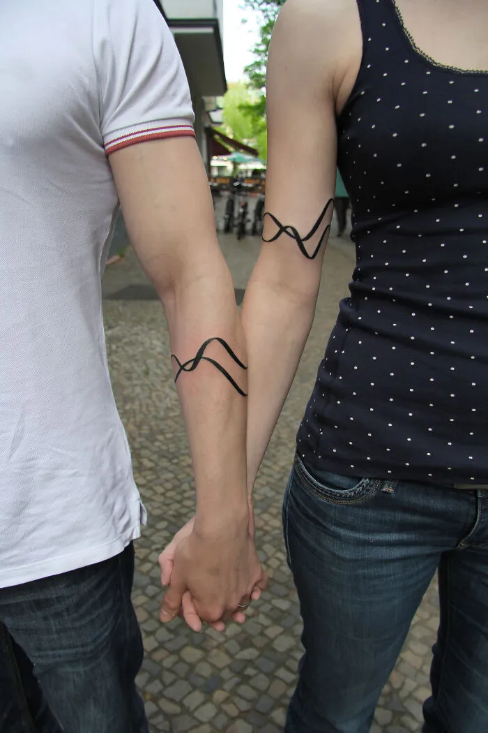 These 15 Couple Tattoos Blur The Line Between Two Individuals And One Design
