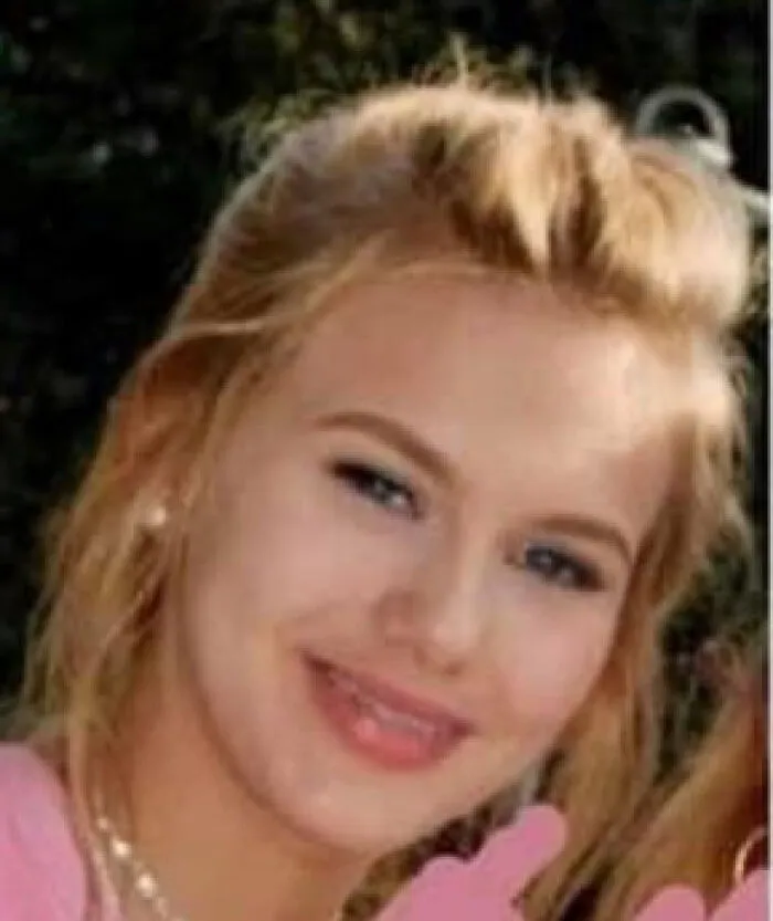 Young woman with blonde hair smiling softly, representing creepy and mysterious things people lose sleep over.