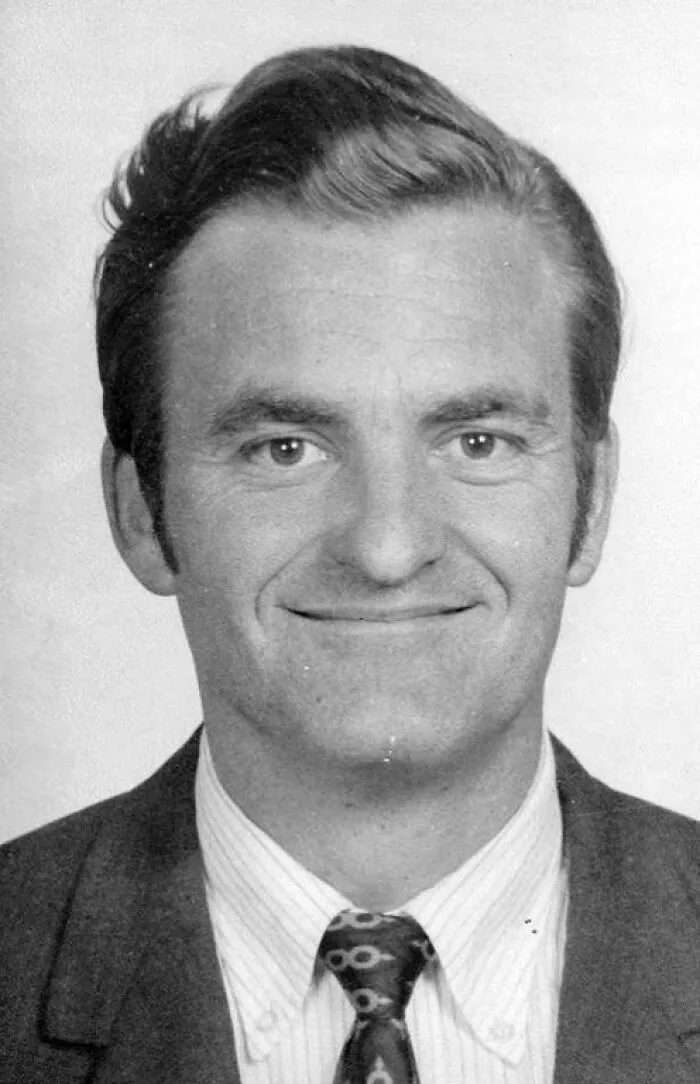Black and white portrait of a man in a suit and patterned tie, evoking creepy and mysterious things that lose sleep over.