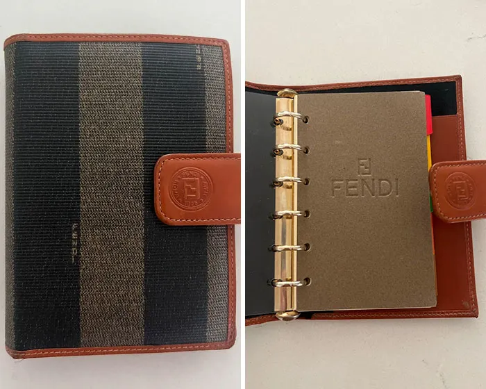 A Fendi planner found in Goodwill Bins, showcasing a brown and black striped exterior and interior Fendi logo.