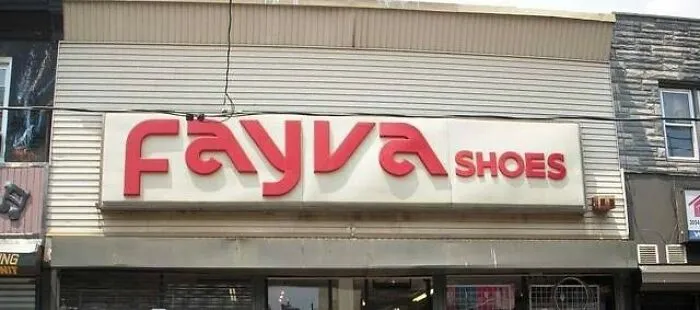A red Fayva Shoes sign on a white storefront, an old photo that makes people take a trip down memory lane.