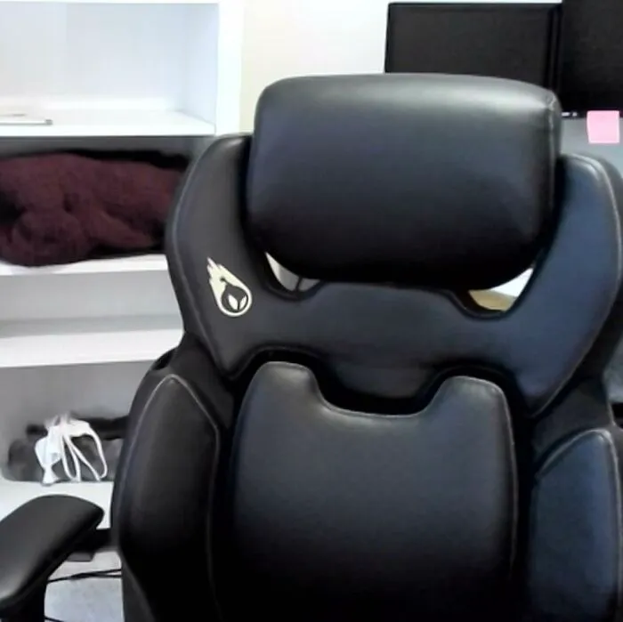 Black leather chair with a design resembling a face, an example of pareidolia in everyday objects.