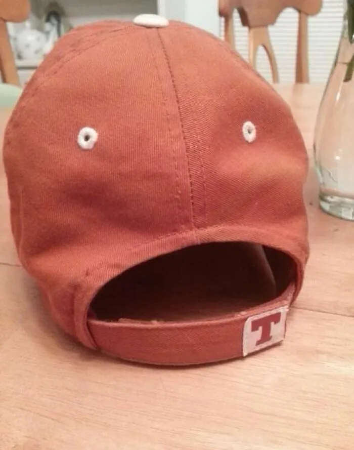 Rust-colored cap positioned to resemble a surprised face demonstrating a classic example of pareidolia effect.