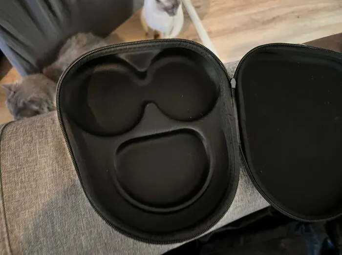Open black case with compartments that resemble a surprised face, illustrating pareidolia phenomenon.
