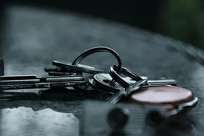 Close-up of keys on a keyring resting on a surface, illustrating essential safety tips for personal security.
