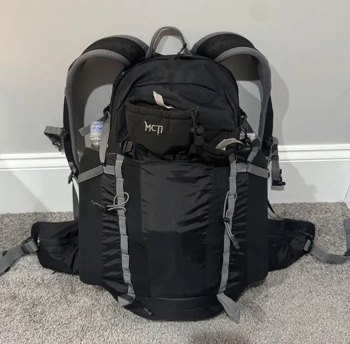 Black hiking backpack with padded straps and multiple compartments, highlighting essential safety tips gear.
