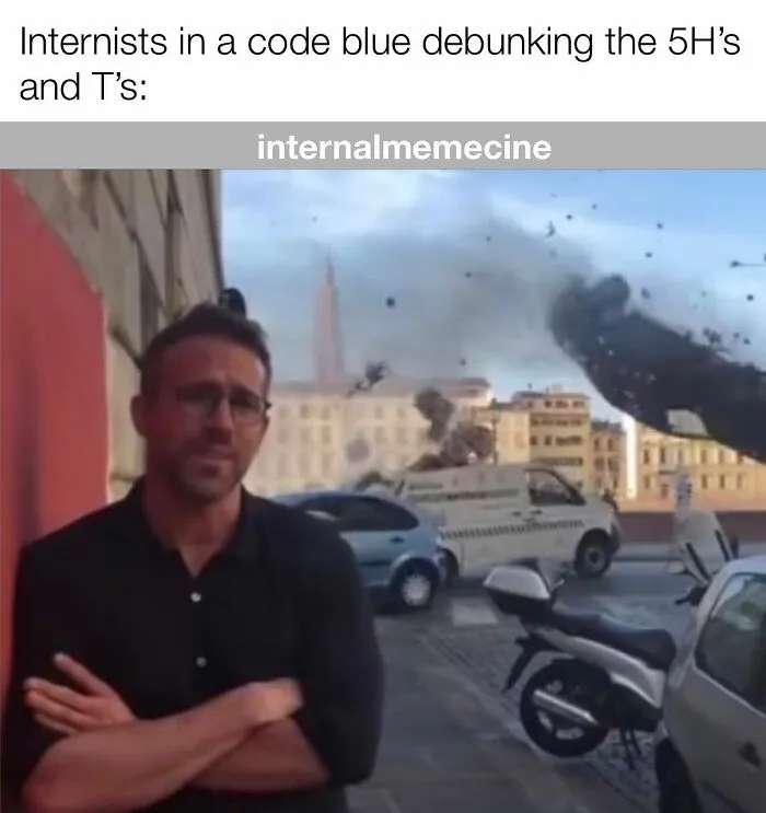 Ryan Reynolds looking calm amidst a city destruction scene, perfect for medical memes for doctors and nurses.