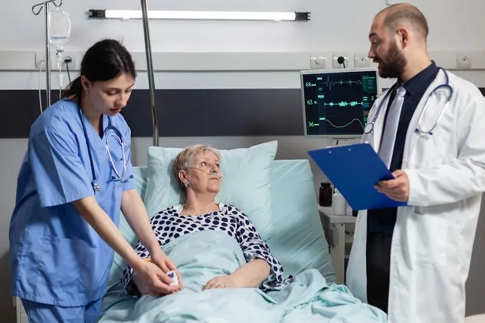 Doctors attending elderly patient in hospital representing conspiracy theory moments explained by facts