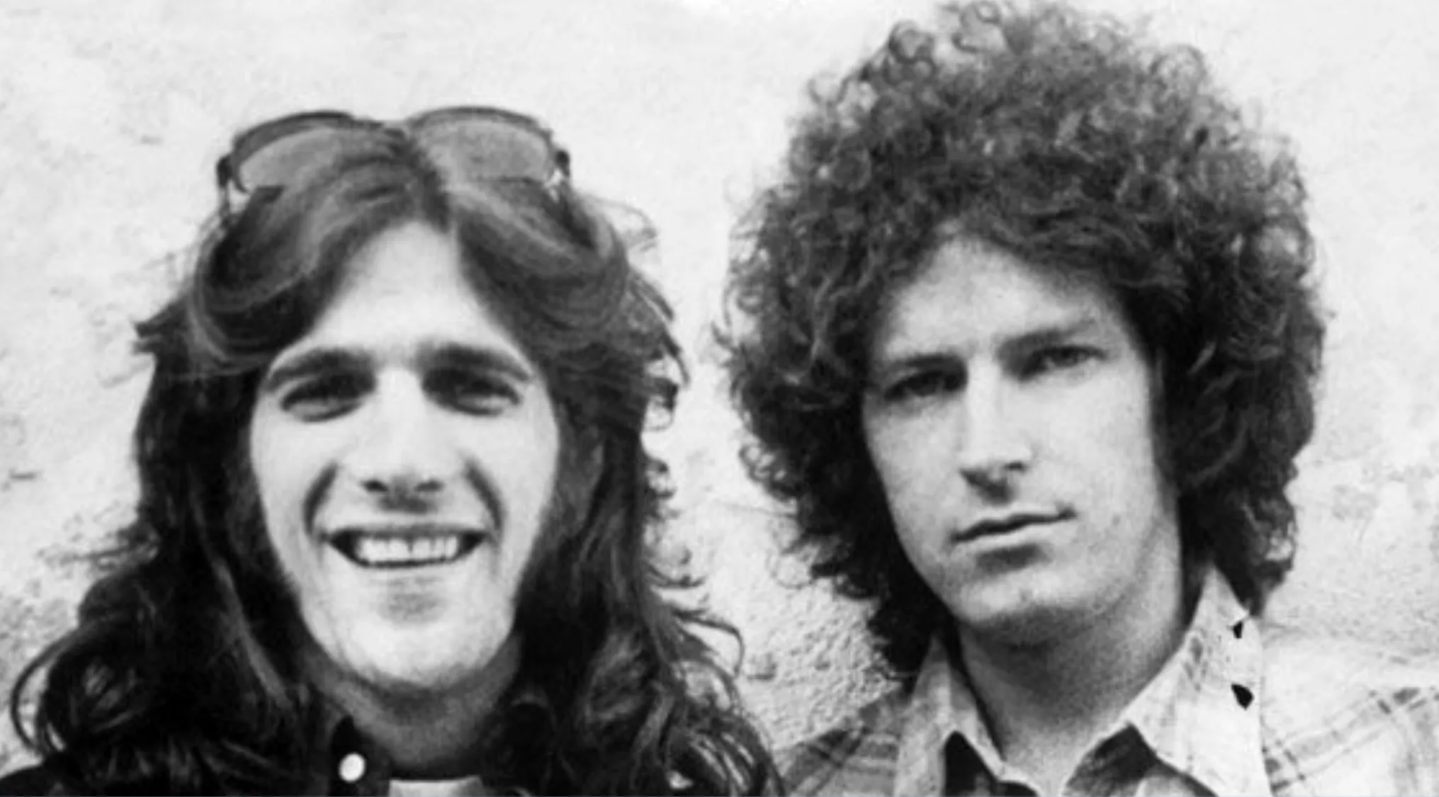 Black and white photo of two lead singers, one smiling, the other with curly hair. Music Challenge: Name 30 Bands.