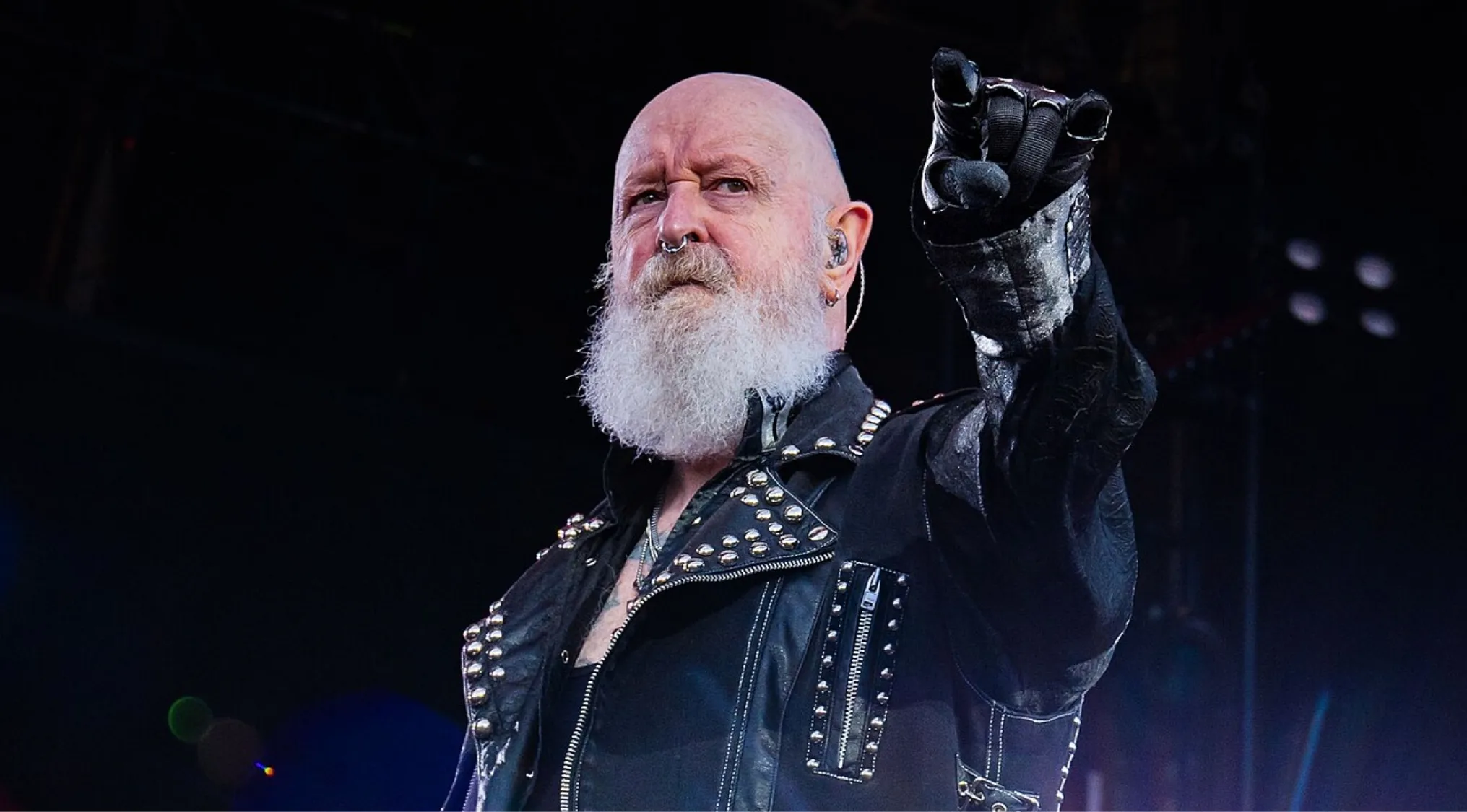 Lead singer in a studded leather jacket, with a long white beard and a nose ring, pointing his finger, inviting you to identify the band. Music challenge!