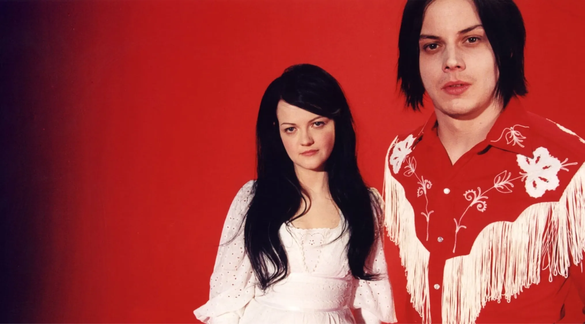 Music Challenge: The White Stripes, an American rock duo, Meg White in white and Jack White in a red fringed shirt.