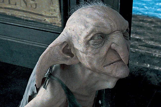 A close-up of a house-elf, with large ears and pale skin, looking contemplative. Which mythical creature are you?
