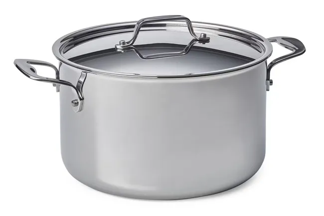 A shiny, new metal cooking pot with a glass lid, featuring two sturdy handles, on a white background.
