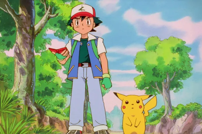 Ash Ketchum and Pikachu from Pokémon in an animated scene, standing in a lush, green forest with trees and a blue sky.