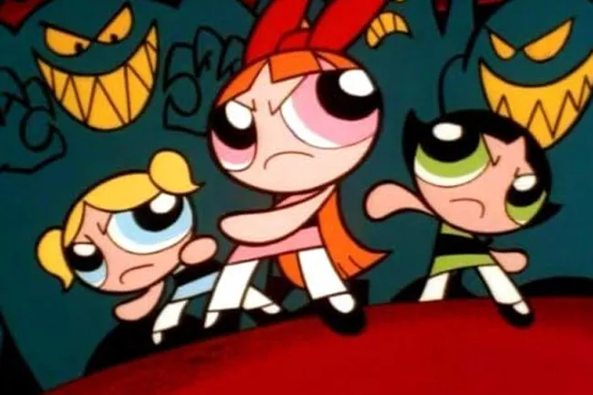 The Powerpuff Girls, Blossom, Bubbles, and Buttercup, with determined expressions, stand ready to fight menacing shadowy figures in the background.