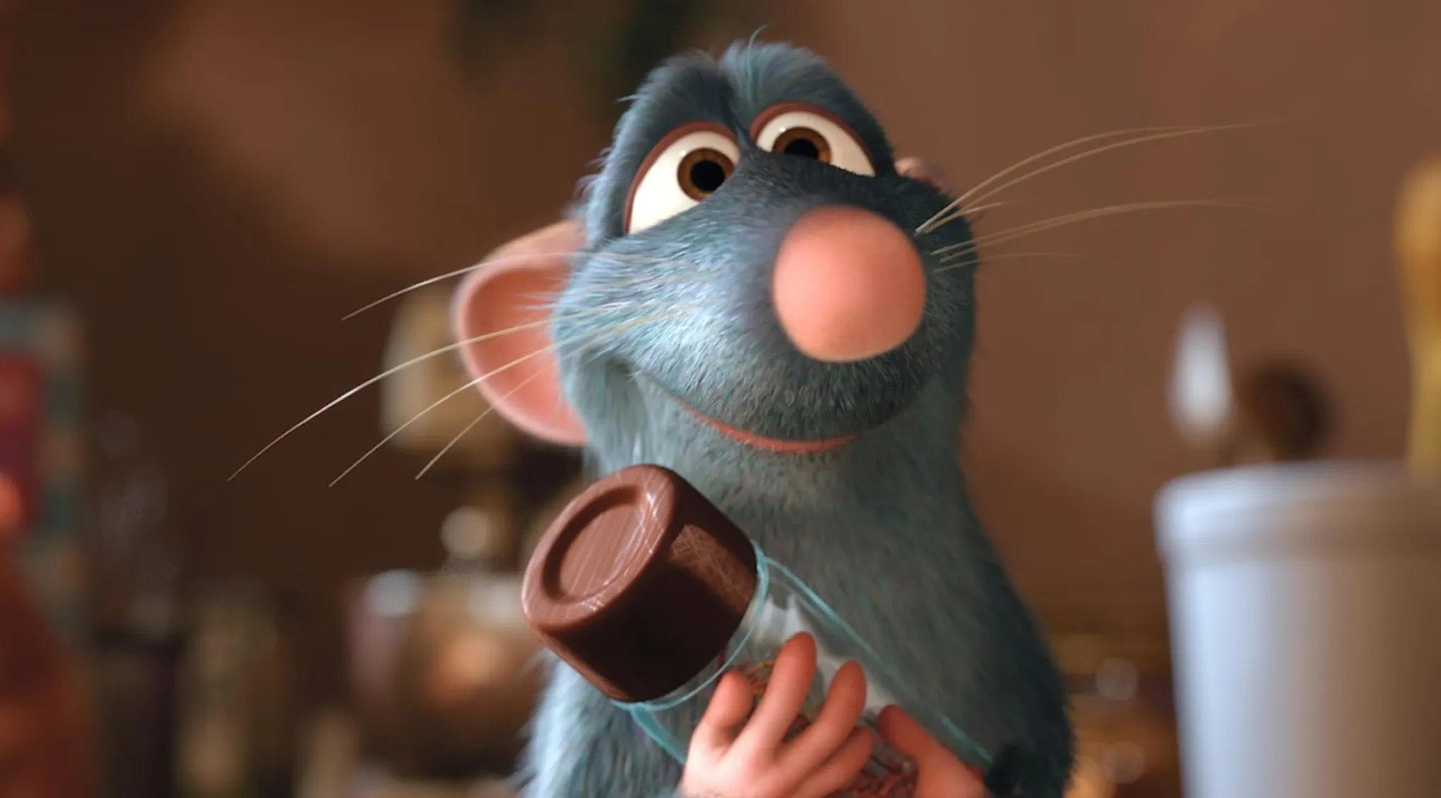 Name This Character: Remy the rat holding a spice jar with a joyful expression, ready to cook.