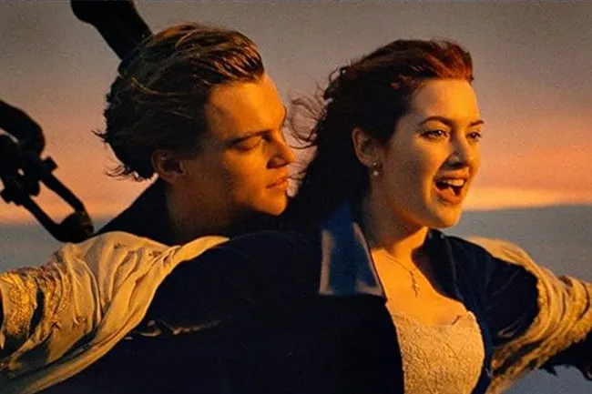 Jack and Rose from Titanic, embracing on the ship's bow at sunset. A classic movie scene with a romantic feel.
