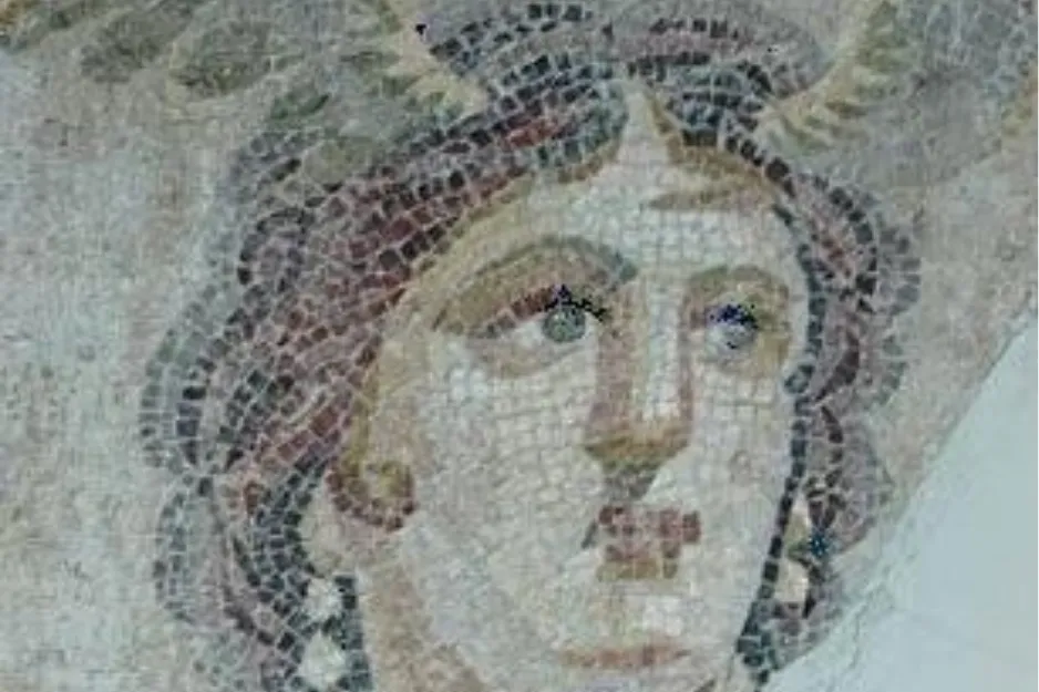 Ancient mosaic art of a female face, possibly Tethys, the Olympian messenger of the gods, with intricate tile work.