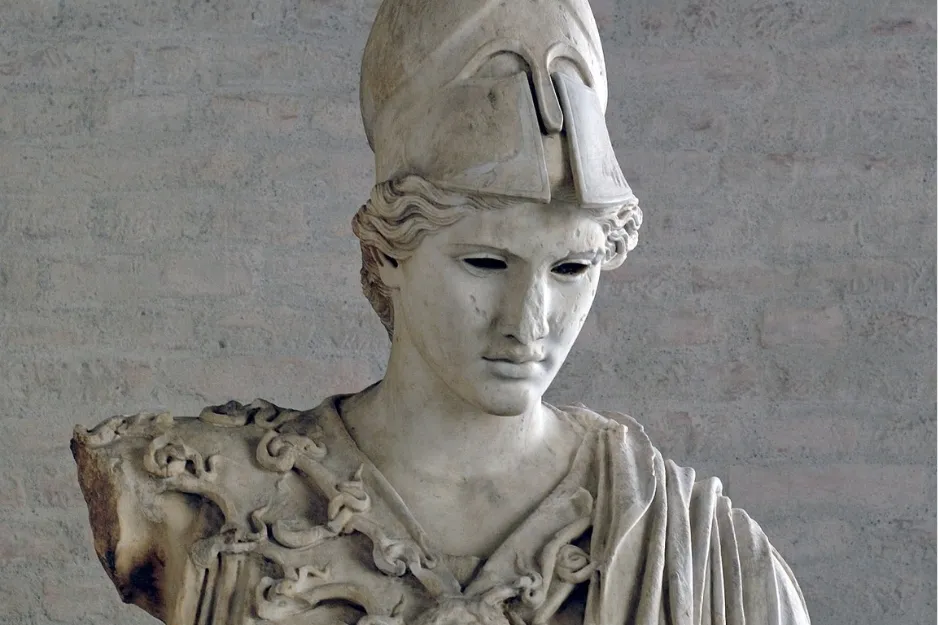 Close-up of a white marble statue of Athena, an Olympian goddess, wearing a helmet and looking downwards.