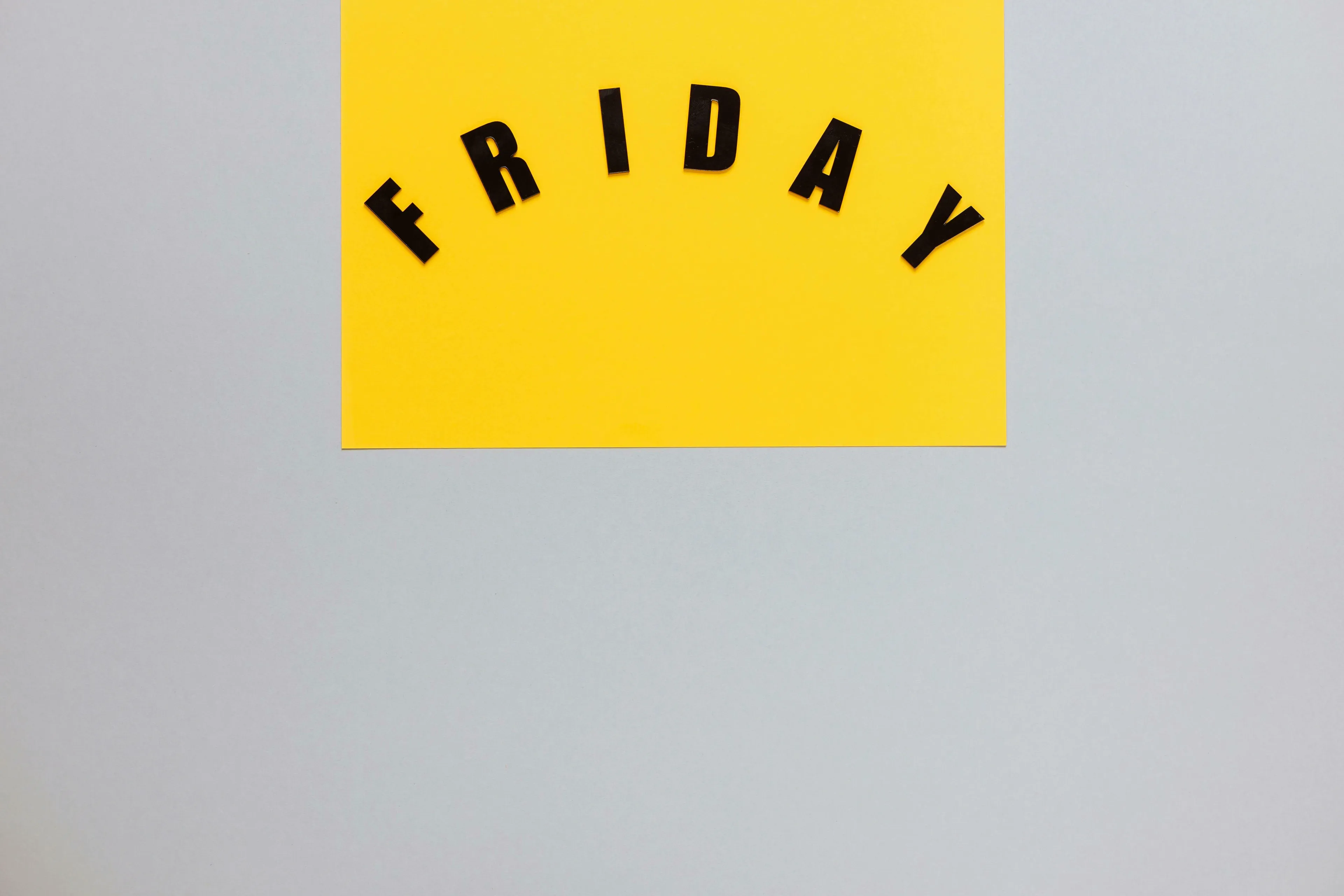 Black letters forming the word "FRIDAY" on a yellow background, symbolizing The Great British Vocabulary Quiz.