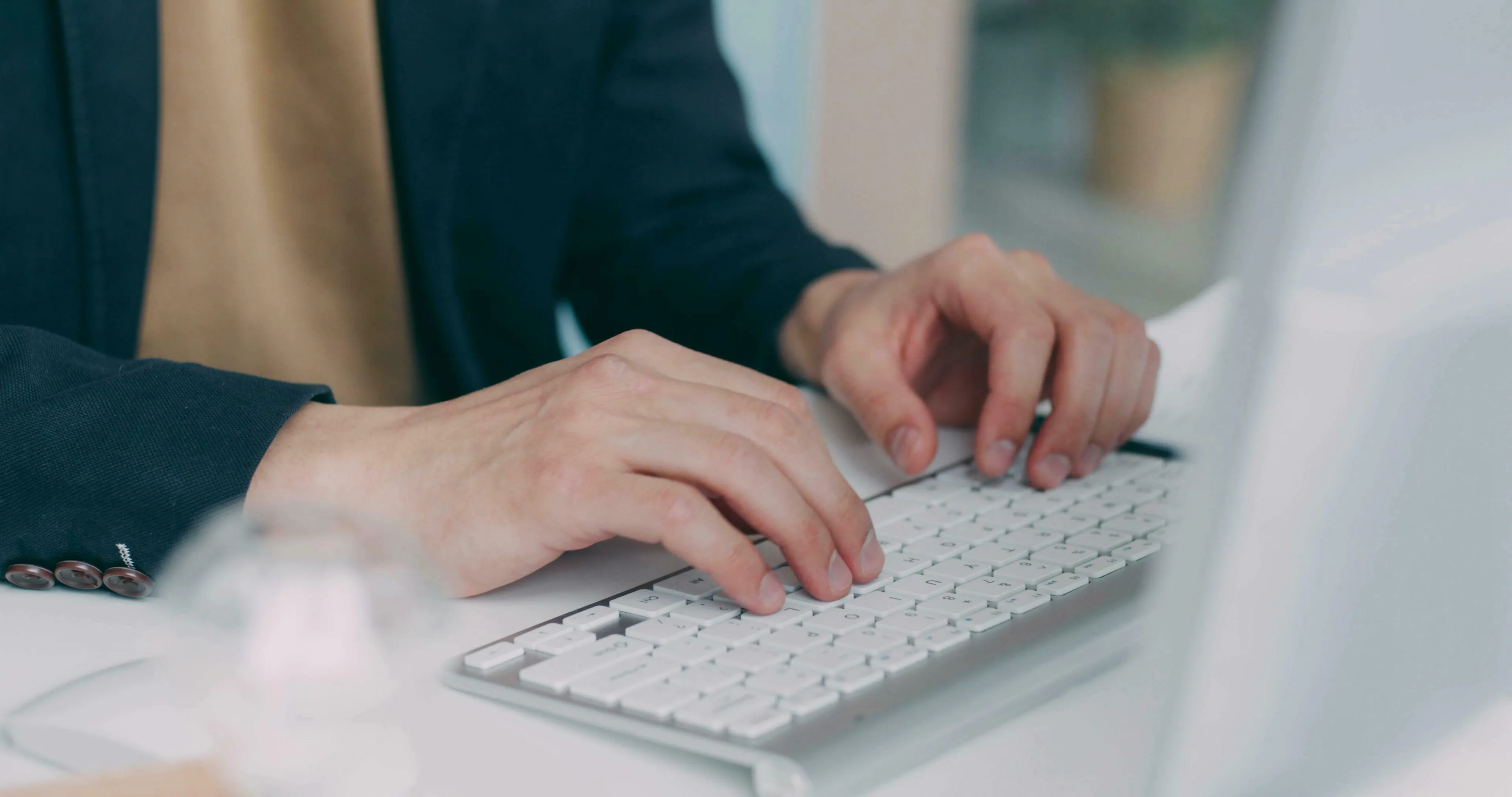 Hands typing on a white keyboard. This image relates to a difficult General Knowledge Quiz for high IQs.
