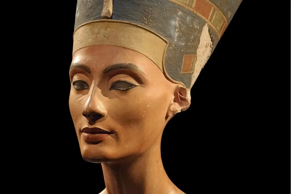 Bust of Nefertiti, the ancient Egyptian queen, wearing a tall blue crown, with a serene expression.