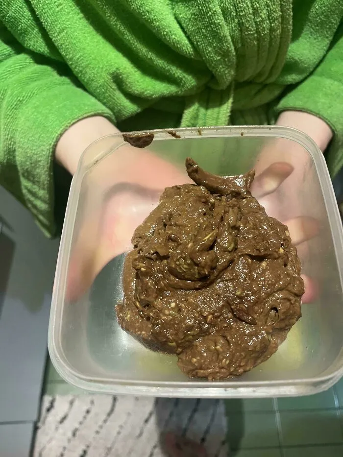 A plastic container holding a thick brown paste, showcasing questionable food combos.