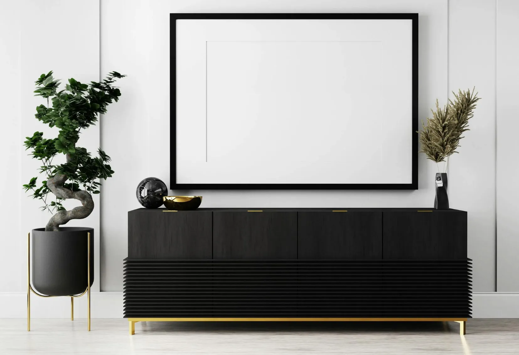 A modern room featuring a black console table, a large blank framed print, and a bonsai plant, exemplifying minimalist black-and-white design.