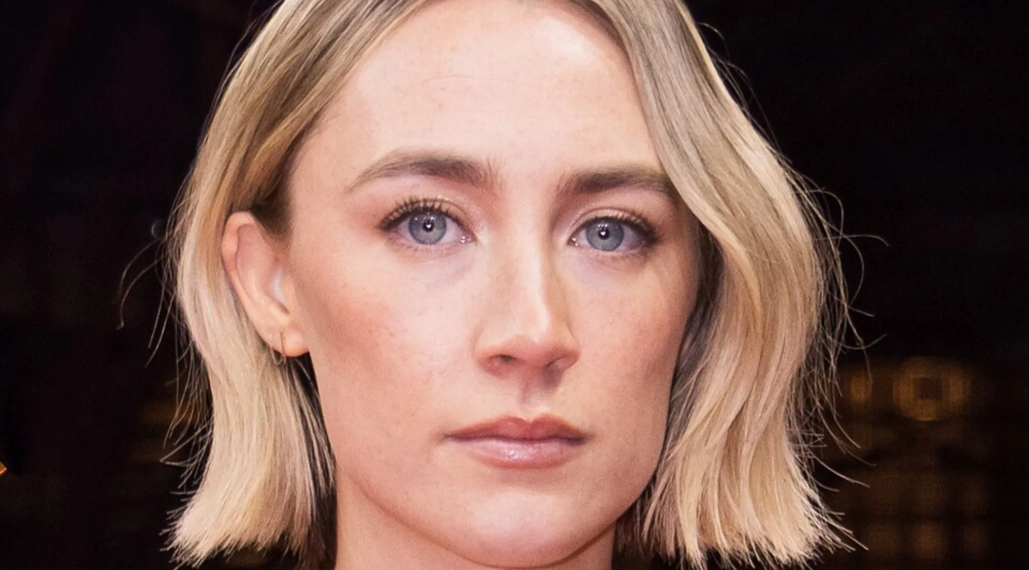 Closeup of actress Saoirse Ronan, blonde bob, blue eyes. Can you spell celebrity names like hers?