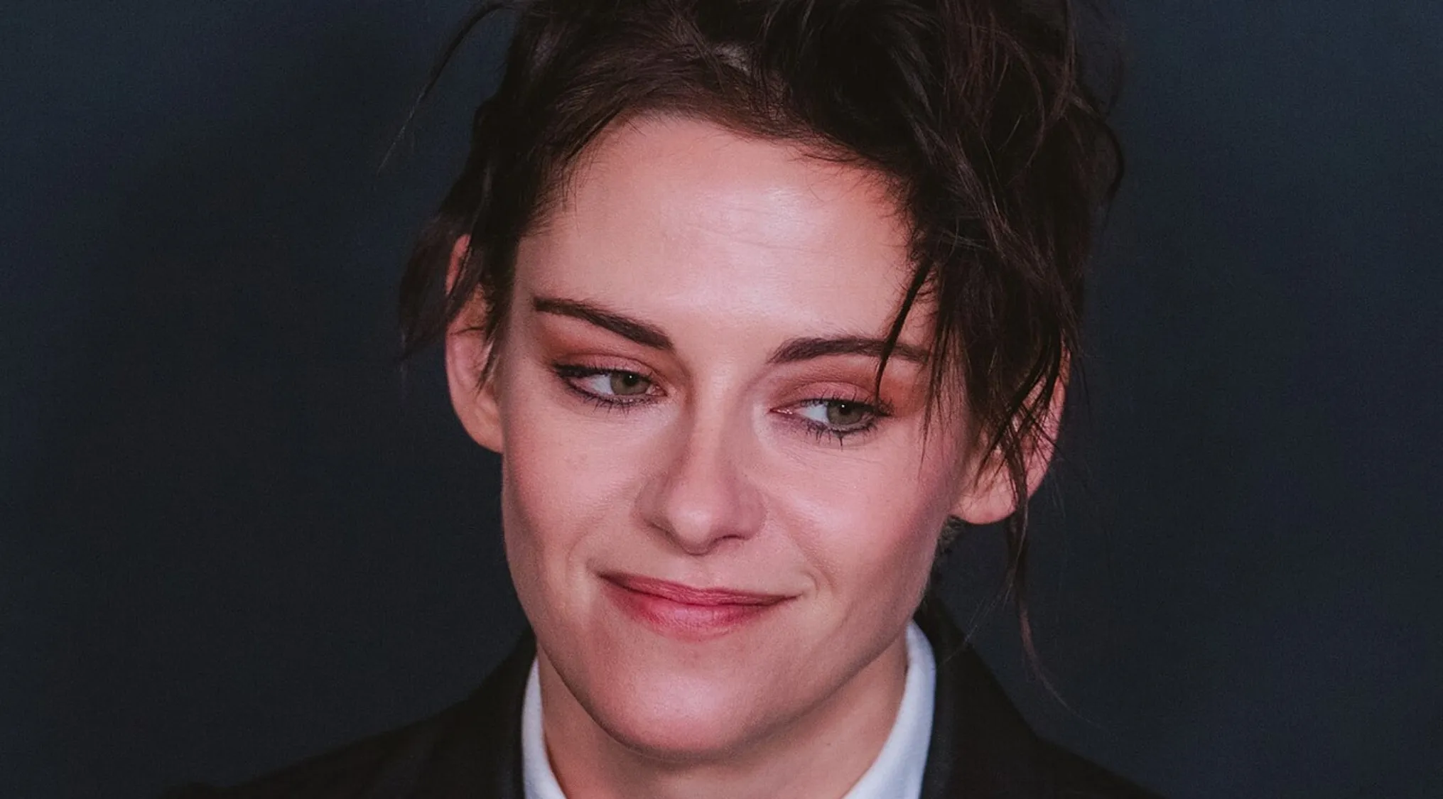 Close-up of Kristen Stewart looking down and smiling. How do you spell this person's name correctly? Spell celebrity names.