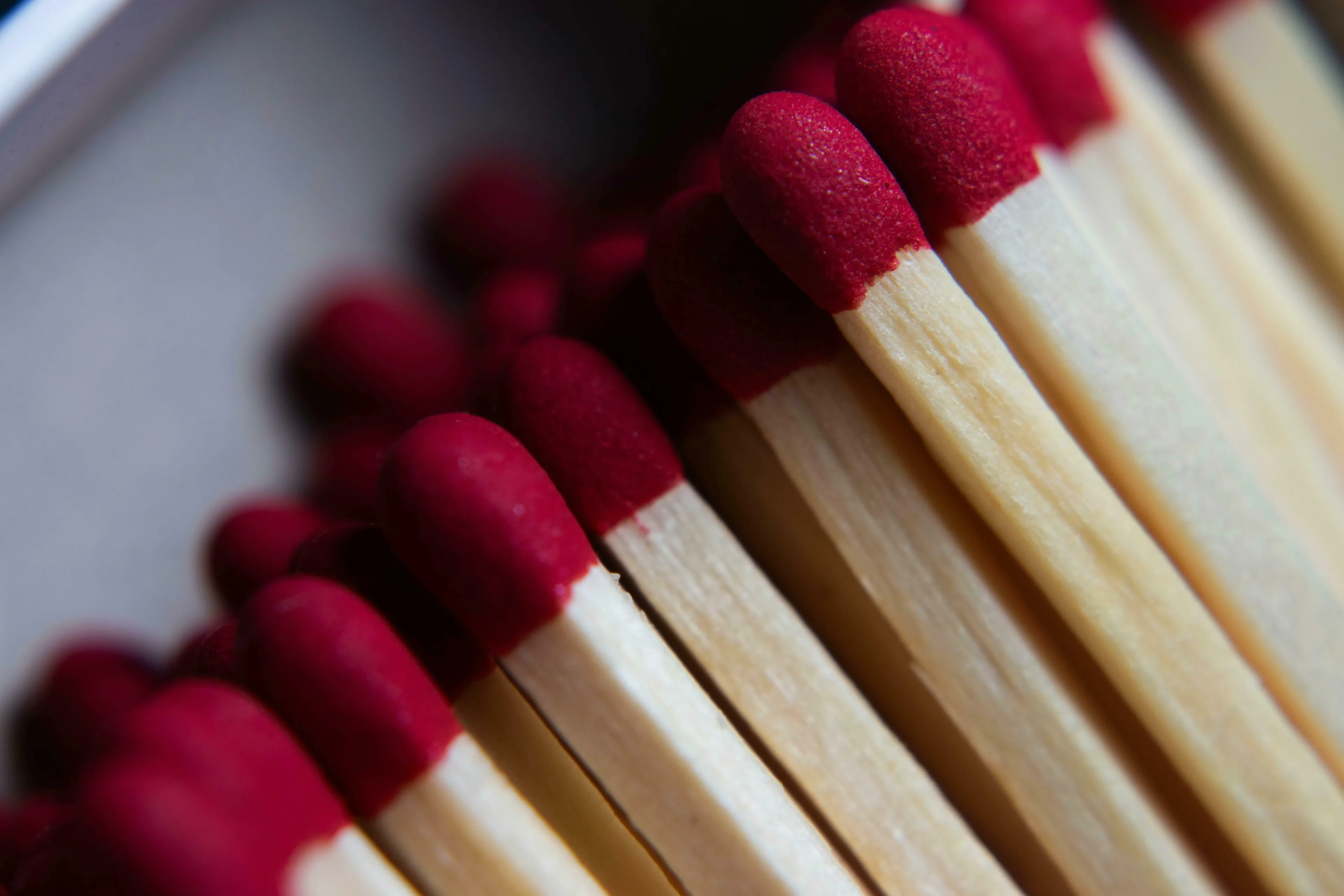 Close-up of red-tipped matches in a box, for Real Or Fake Trivia about lighters and friction matches.