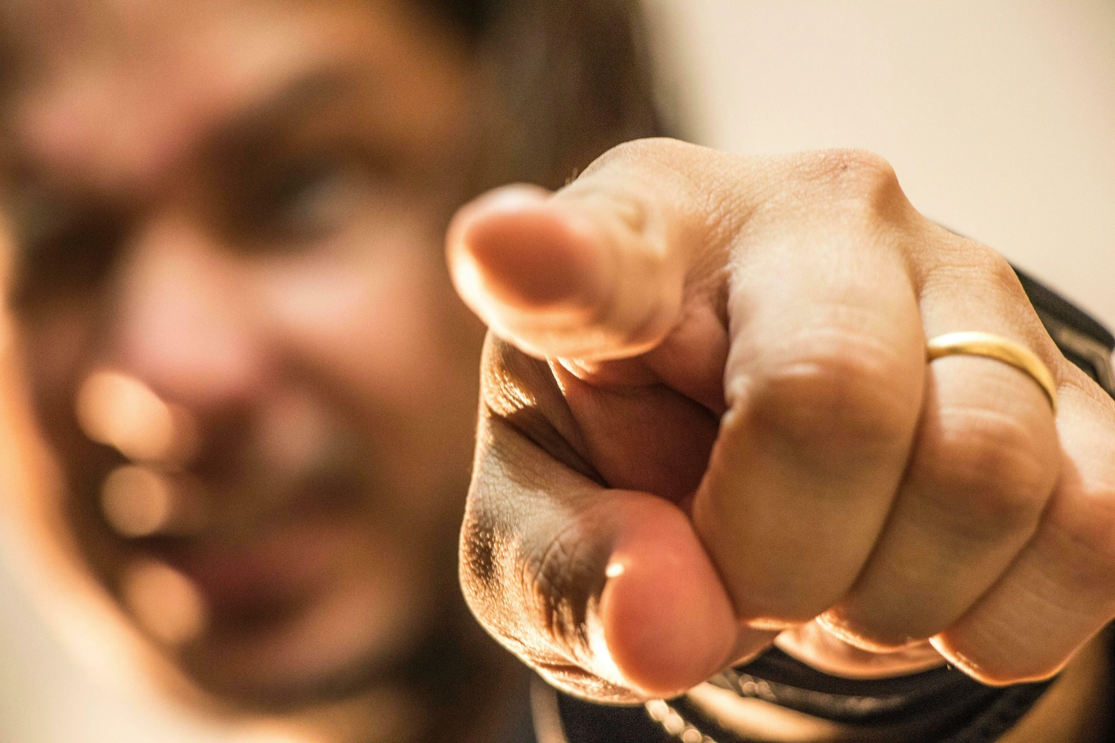 A person points directly at the viewer with an index finger, questioning how unique or unusual you are.