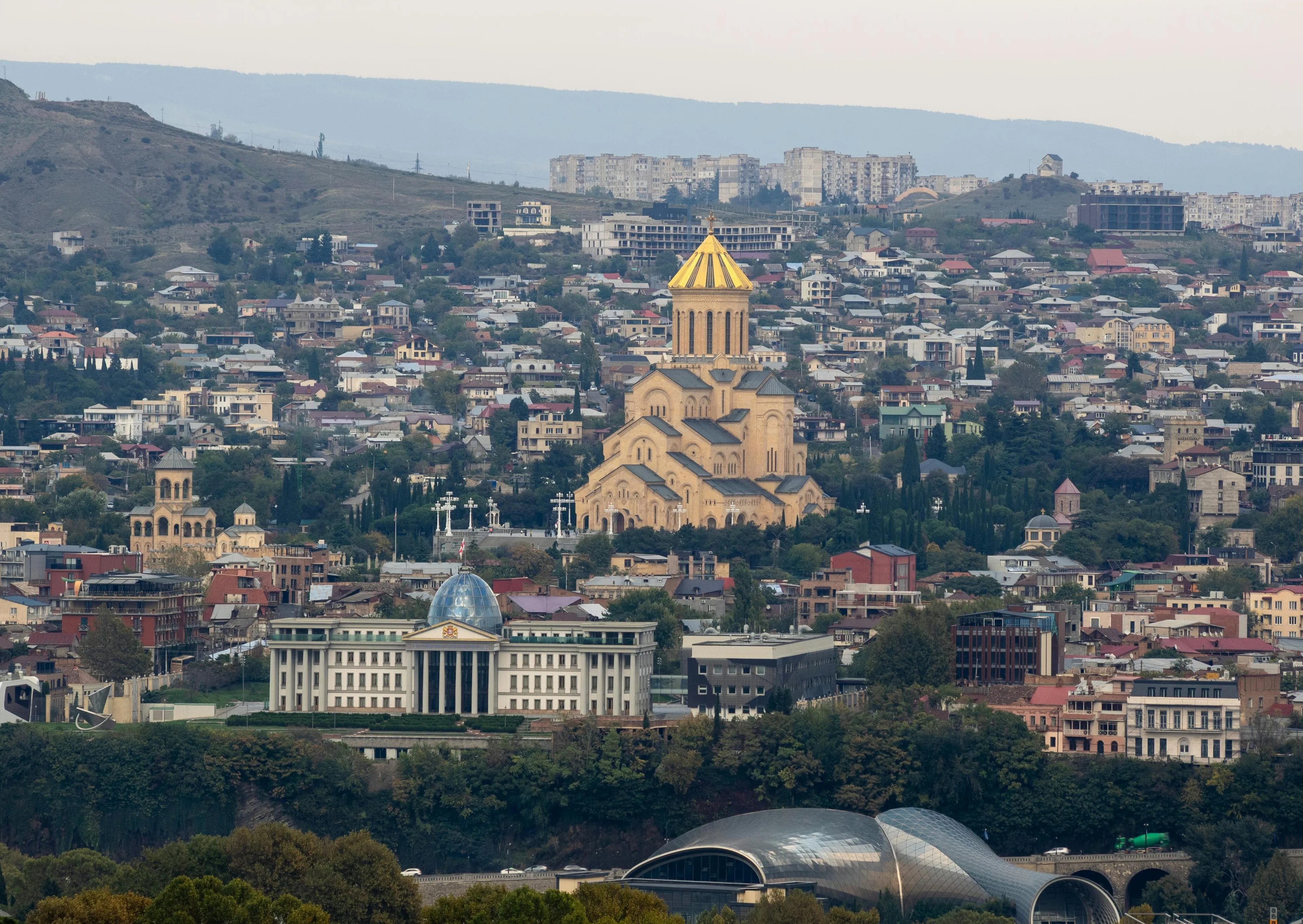 Overhead view of Tbilisi city with the Holy Trinity Cathedral and Presidential Palace prominent, perfect for a long weekend.