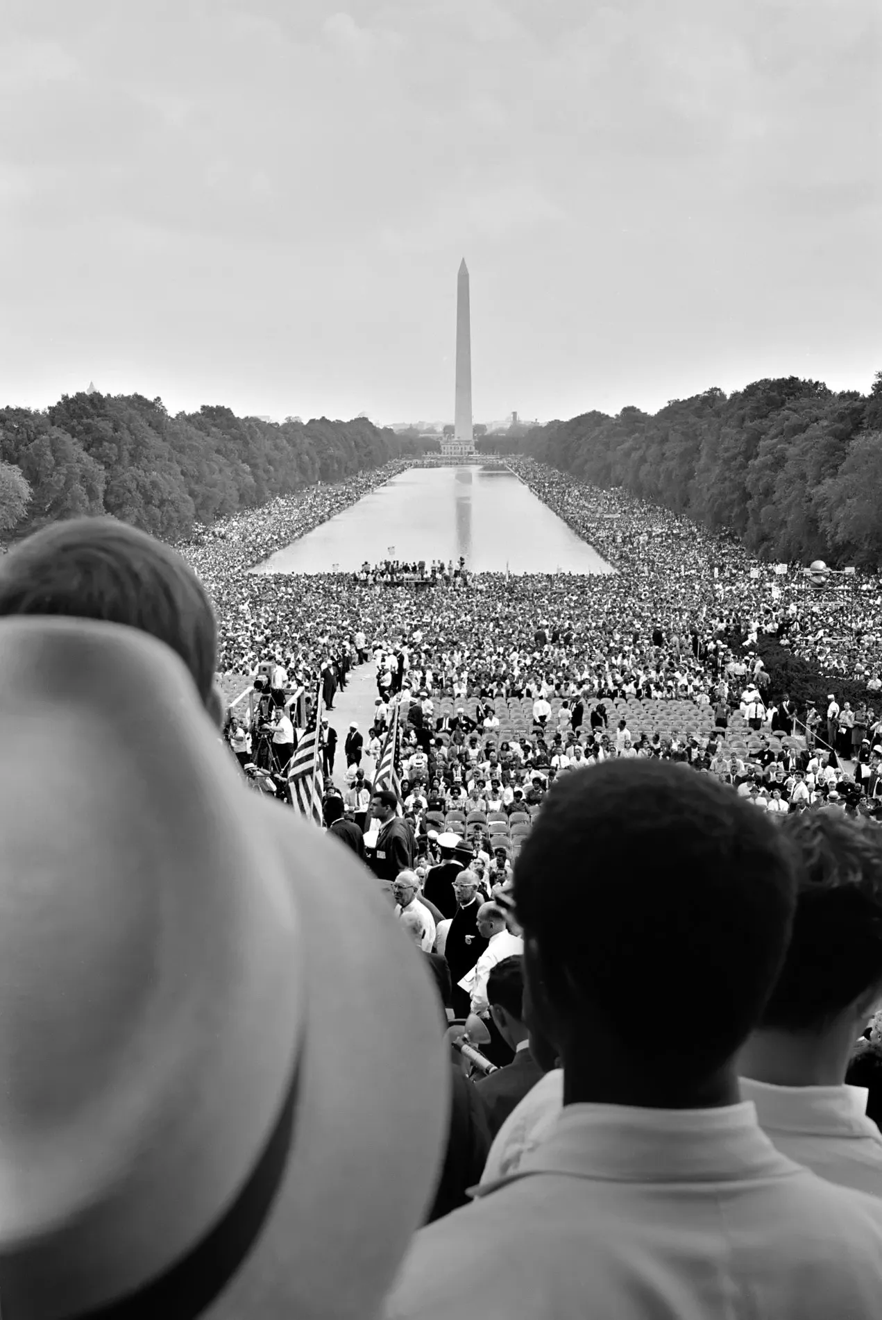 Black and white photo of a massive crowd at the Lincoln Memorial Reflecting Pool, Washington Monument in background. Which event does this photo show?