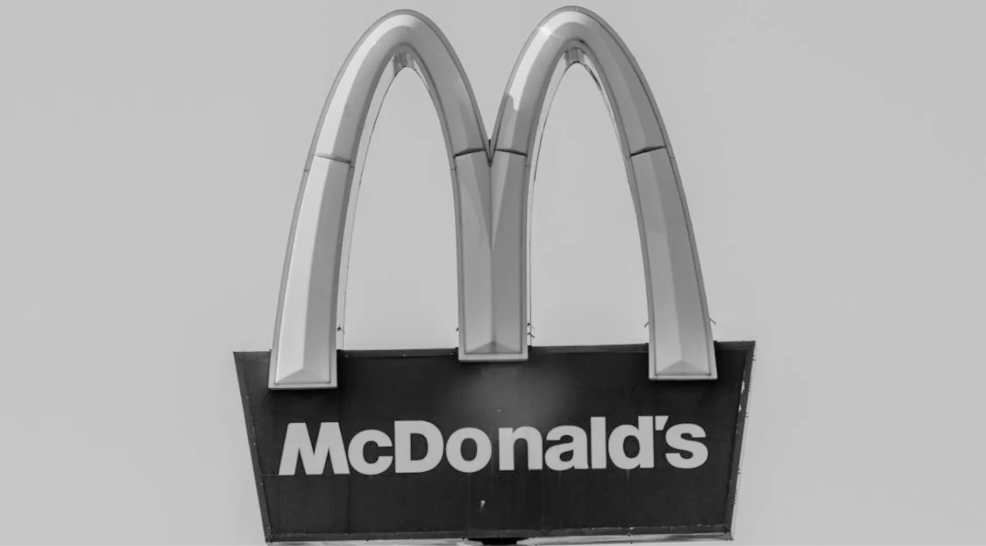 An image showing the McDonald's famous sign in a grey filter