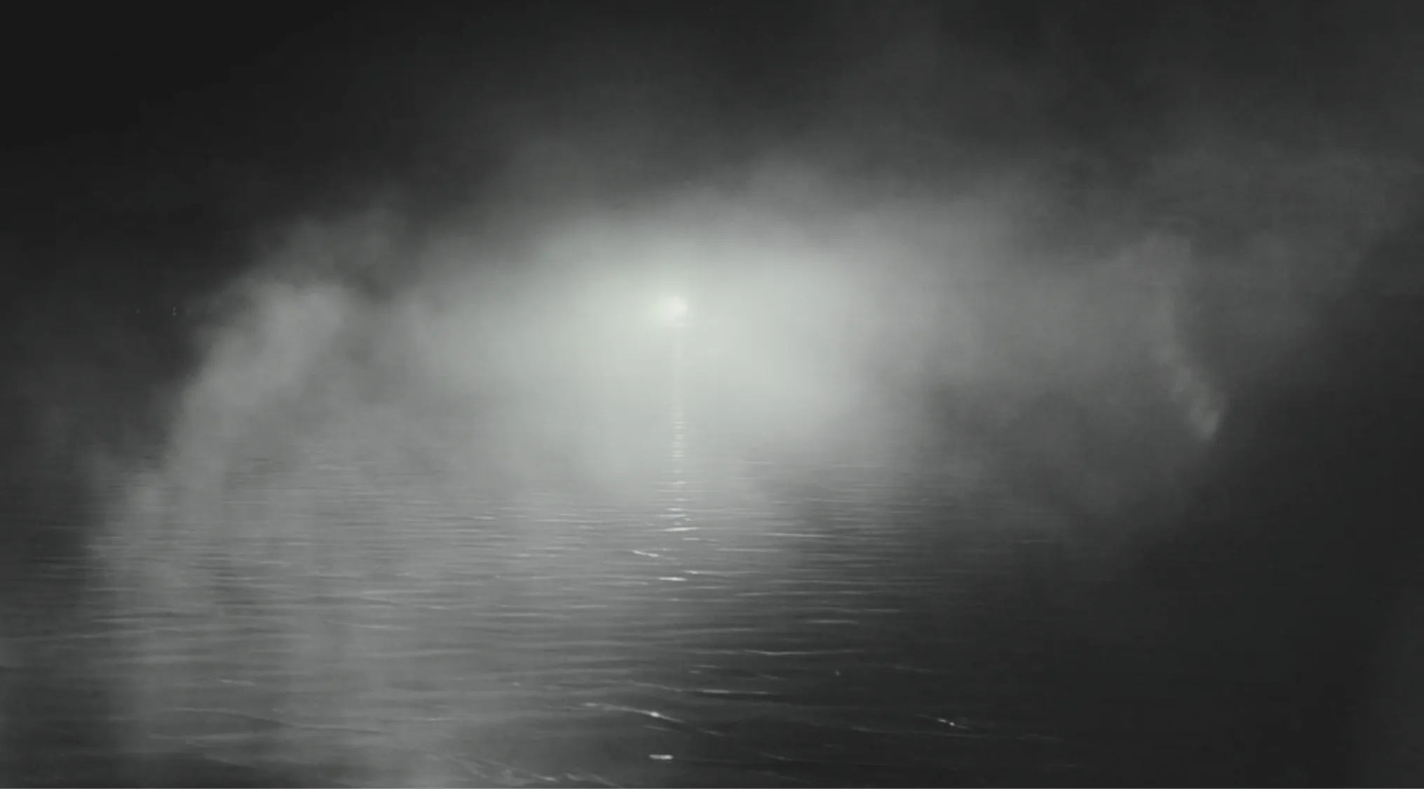 An image showing greyed out water with a light at the end