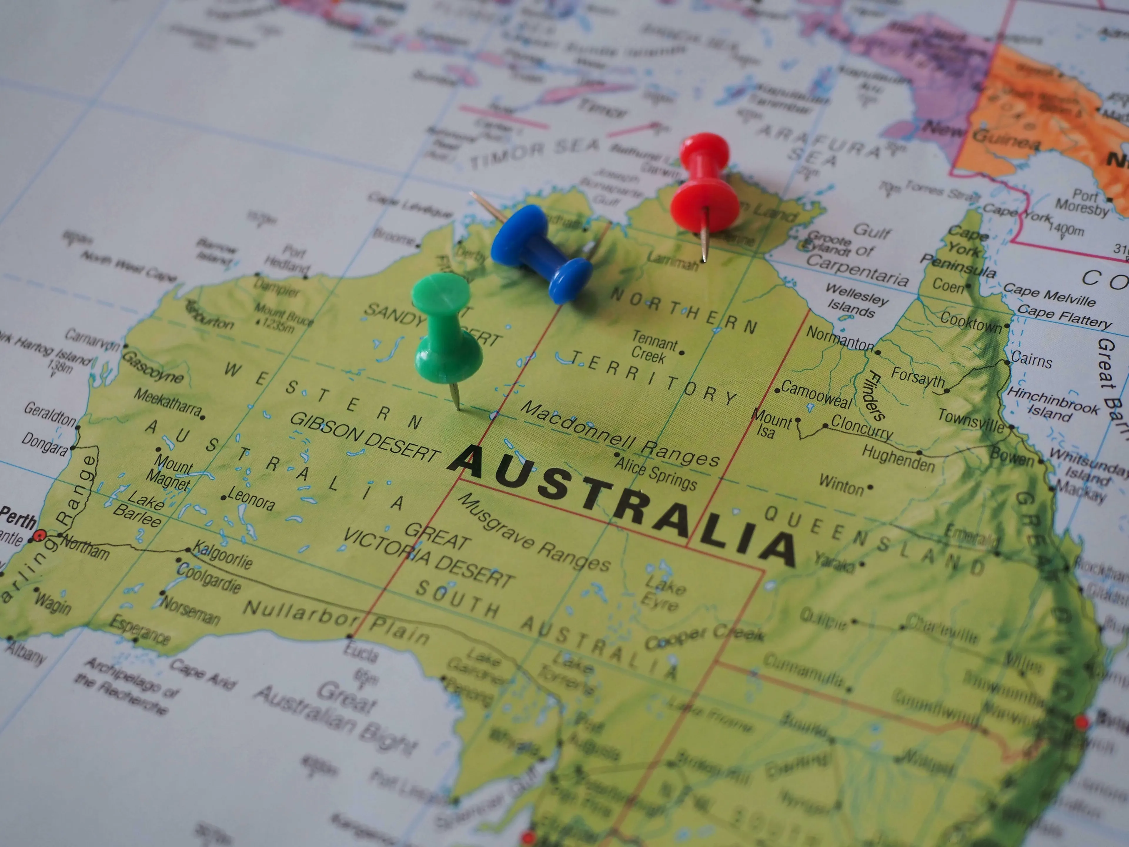 A map of Australia with colorful pushpins, referencing a Millionaire question about Australia's hemisphere.