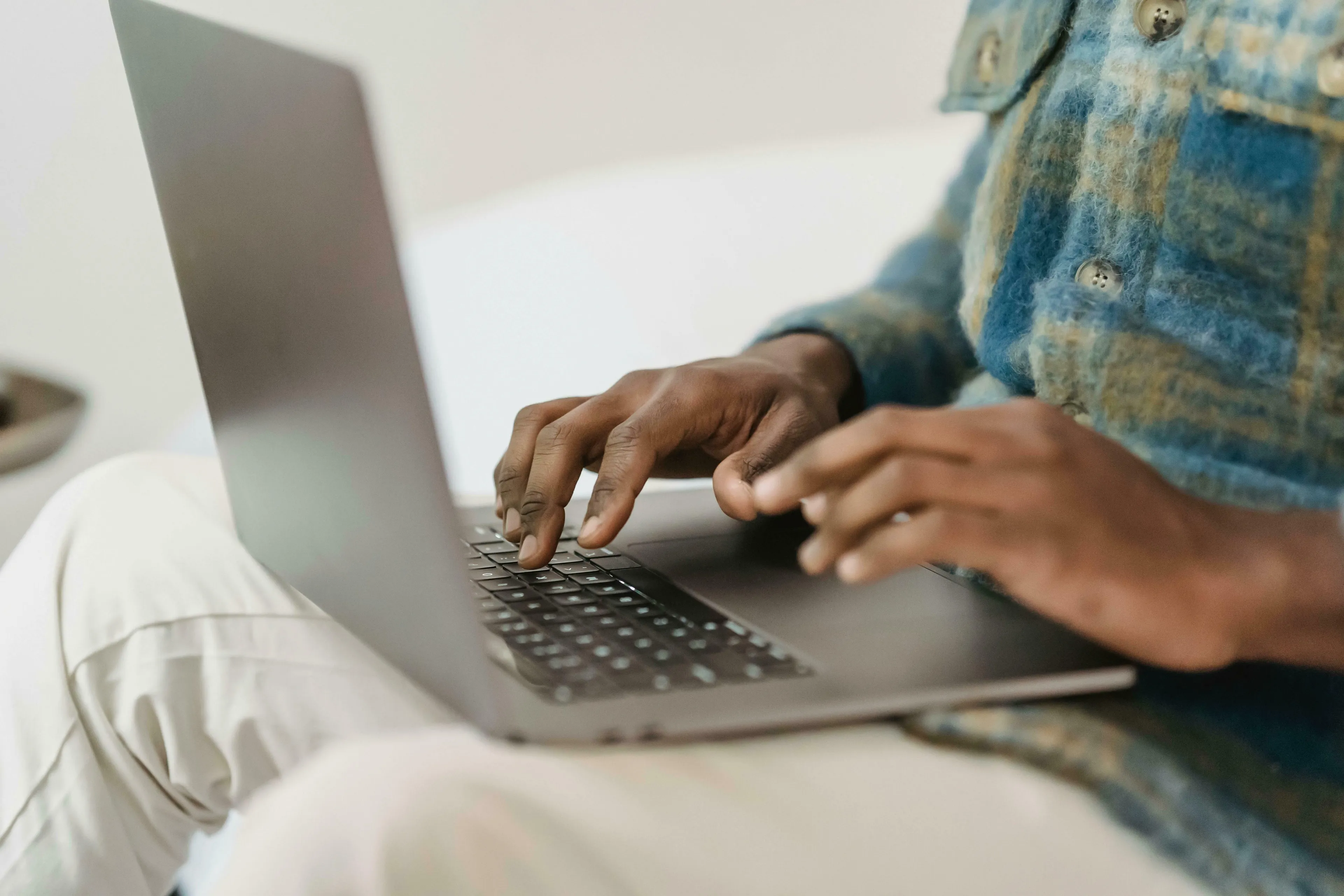 Hands typing on a laptop, a scene common when answering Who Wants To Be A Millionaire questions, like the $1,000 question.