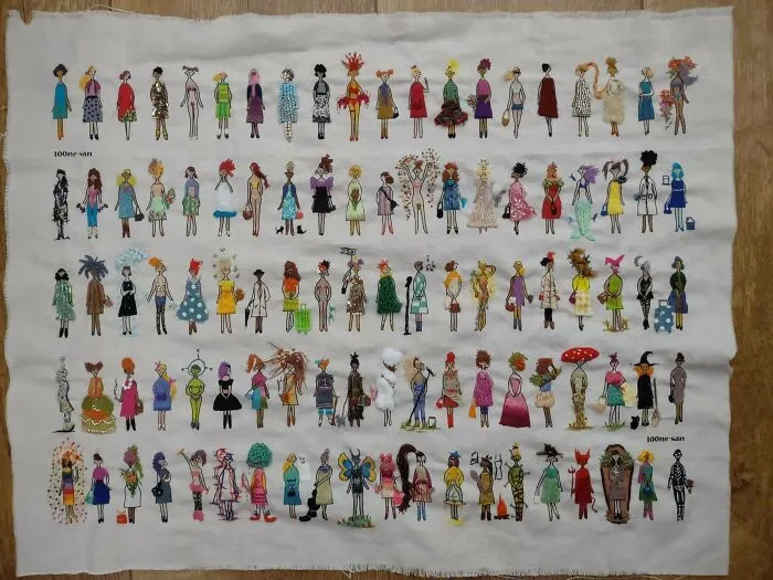 Embroidery projects showcasing row after row of uniquely stitched tiny female figures.