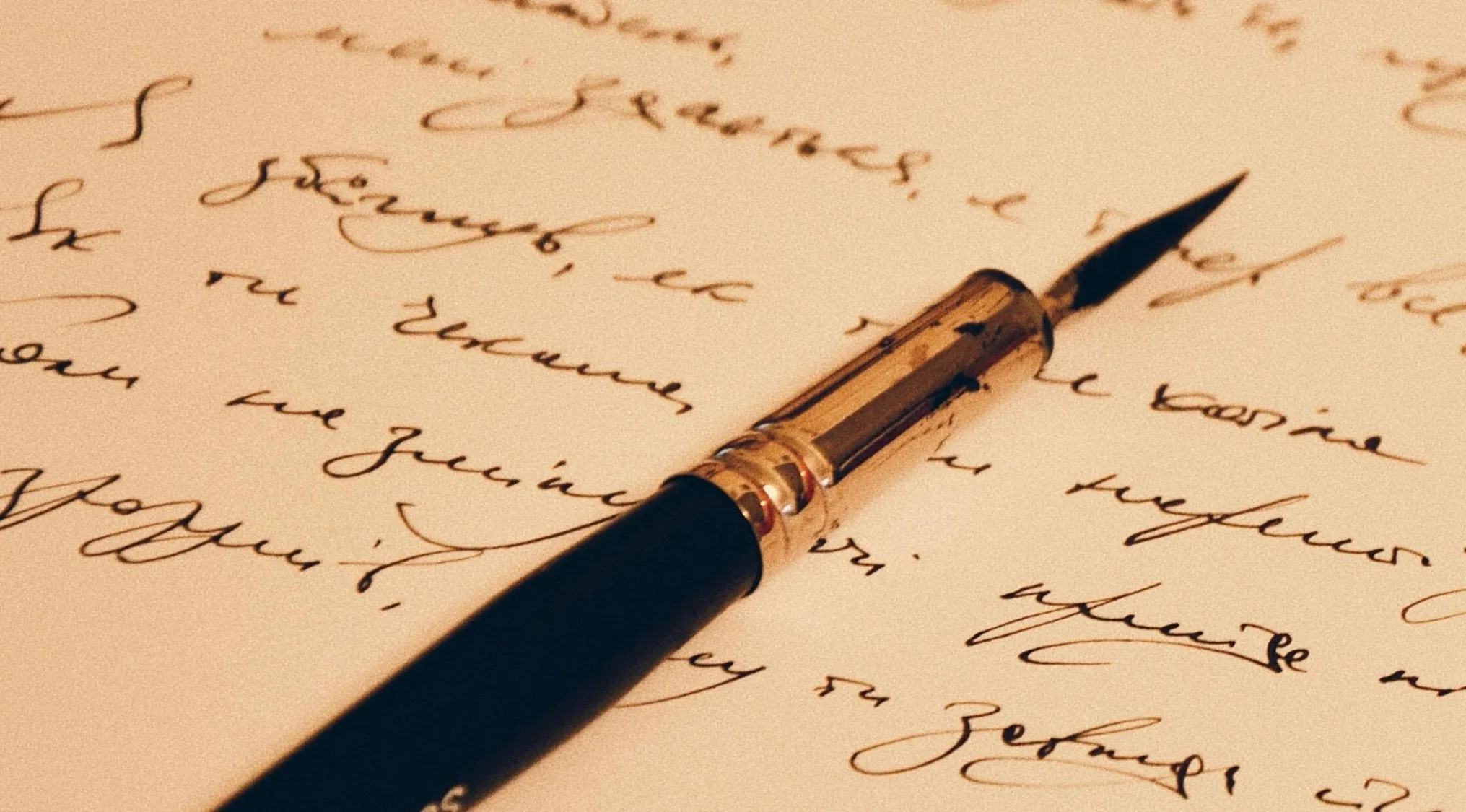 A quill pen on a sheet of paper with flowing, handwritten script. General Literature Trivia: How many lines does a sonnet have?