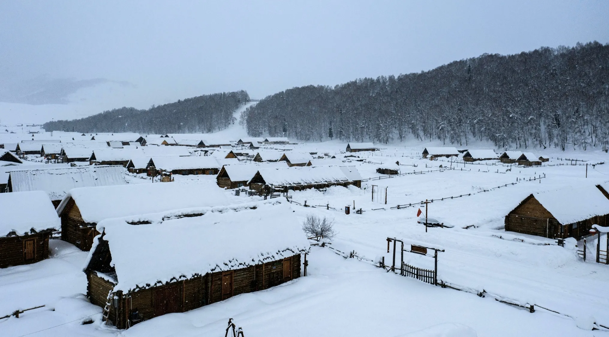 A snowy Siberian labor camp village with wooden houses, evoking images of Russian literature.