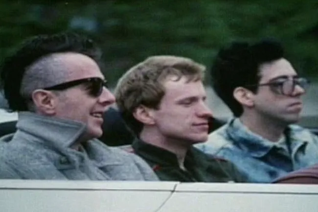 Three men in a car, reminiscent of The Clash, capturing the mood of Should I Stay or Should I Go.